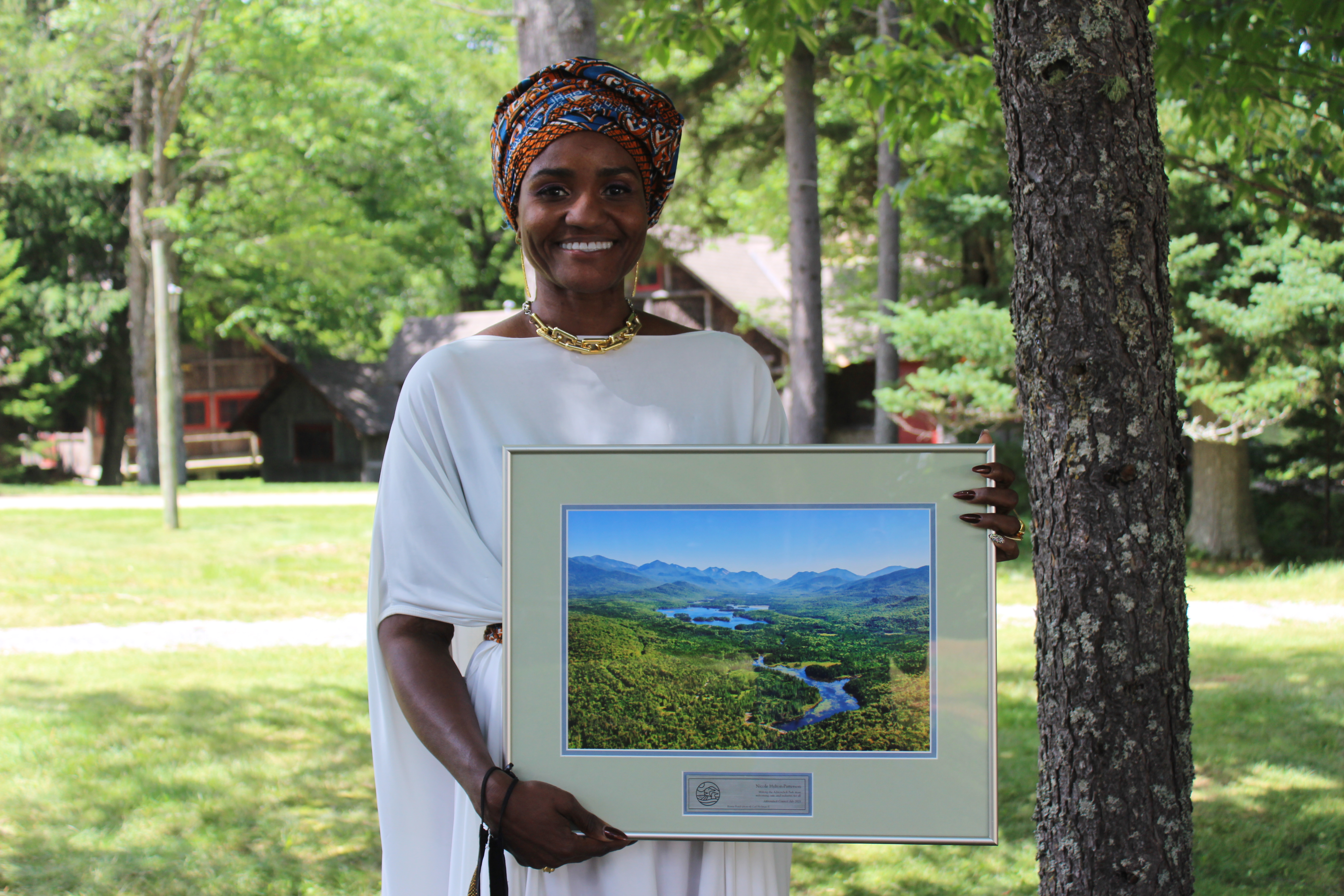 Nicole Hylton-Patterson with an award given to her by the Adirondack Council