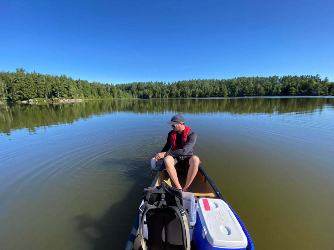 water sampling taking place on a kayak, photo by Adirondack Watershed Institute