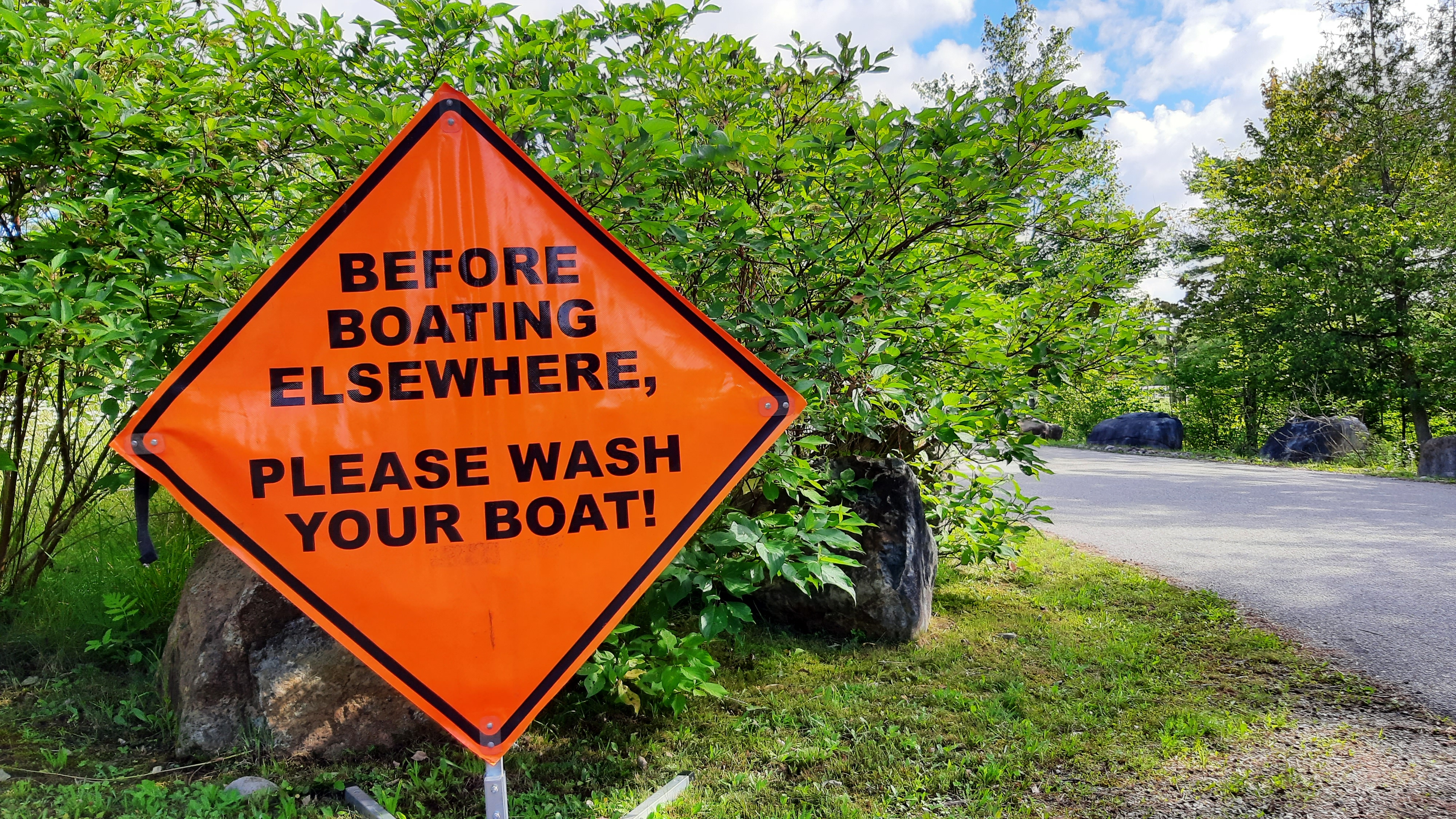 A sign reminds boaters to clean their boats to prevent spreading invasive species
