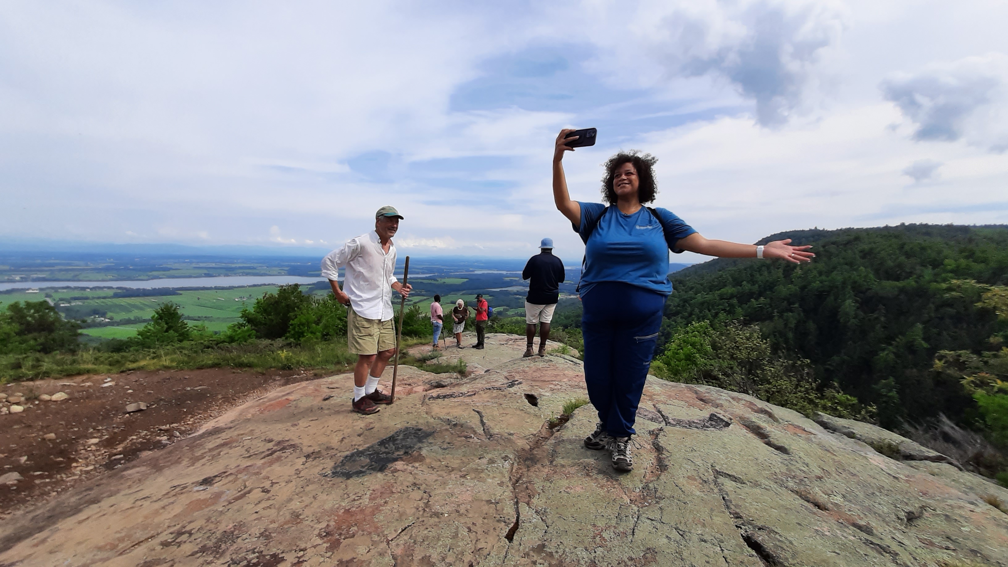 Assemblymember Michaelle Solages takes in the Adirondacks, Champlain Valley, Lake Champlain, and Vermont from the top of Coot Hill