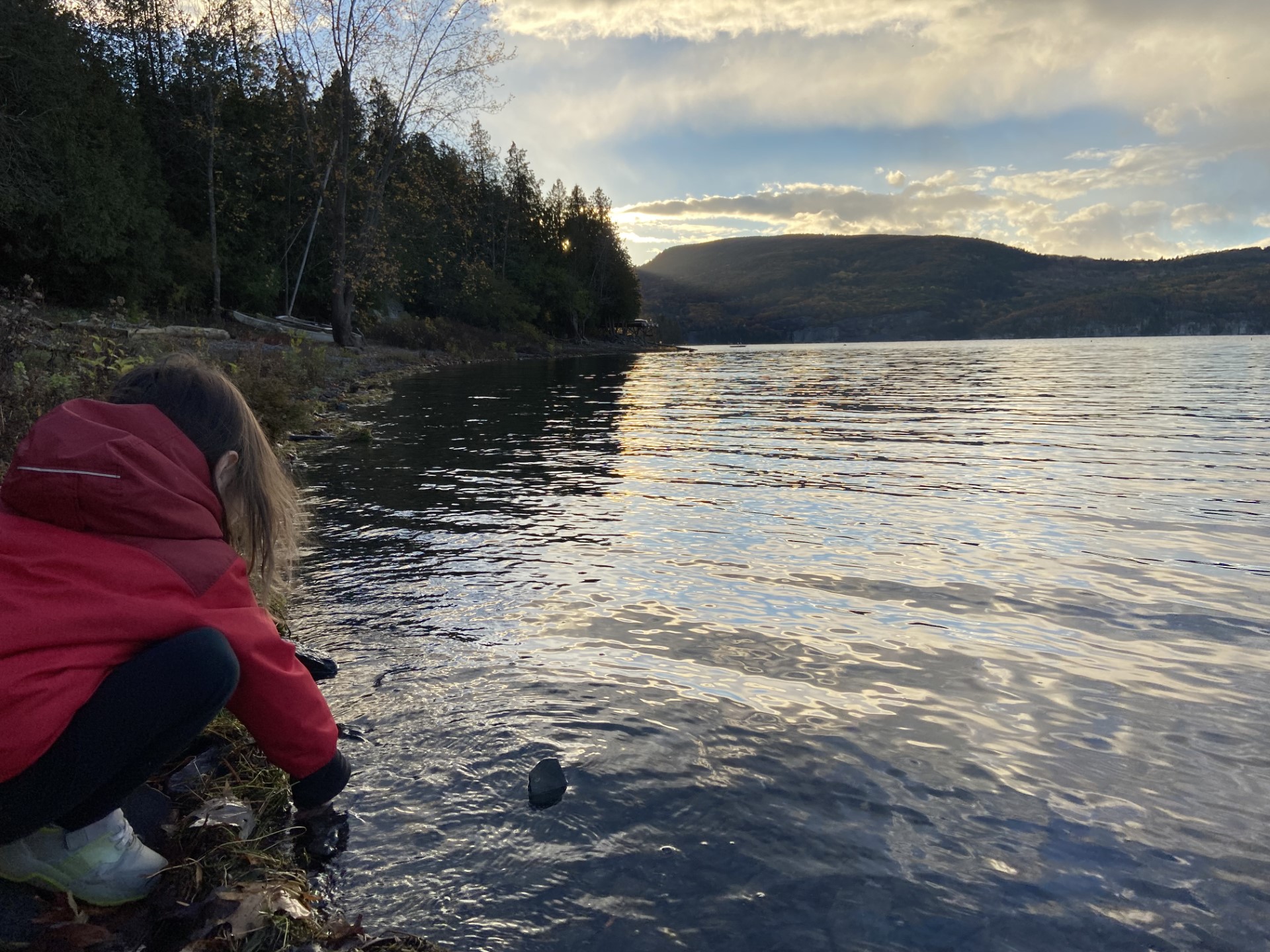 A young girl by a lake