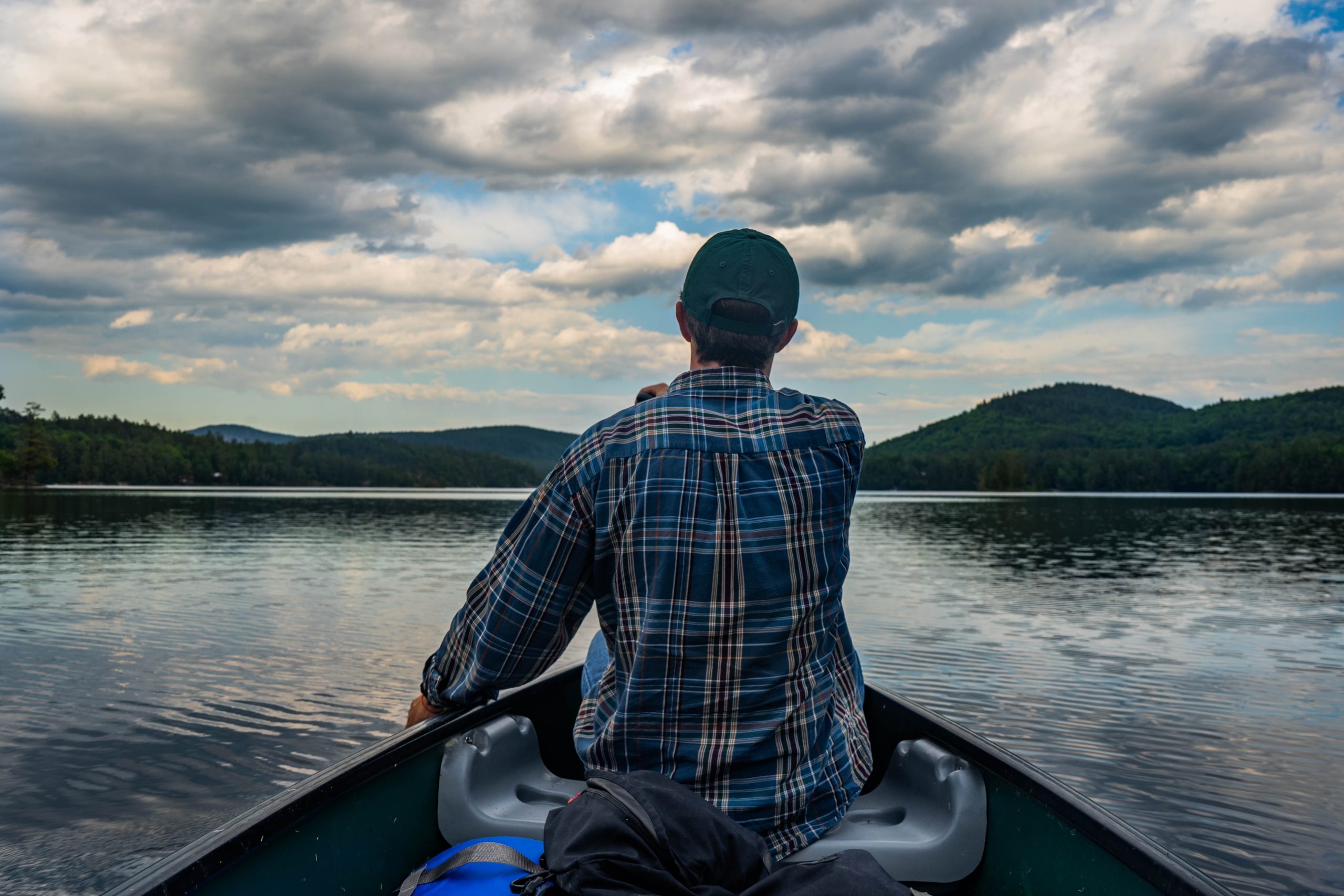 Bryan paddles a canoe on Paradox Lake