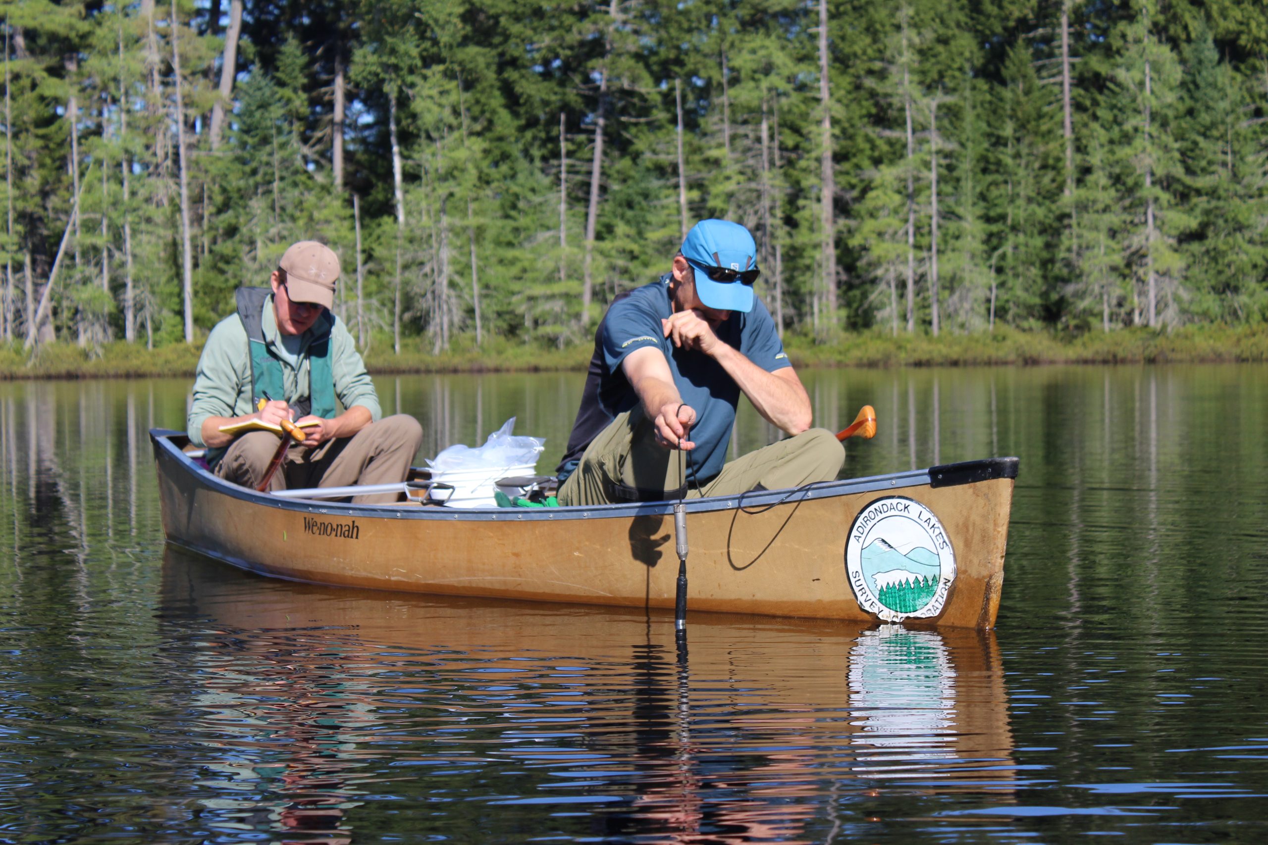 water scientists collect samples in a remote pond