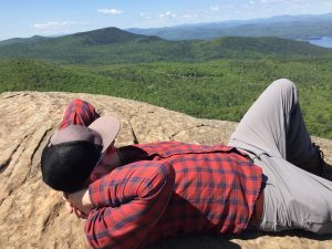 Andrew Williams relaxing on an Adirondack mountain